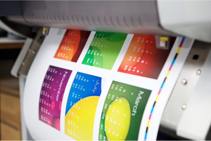 A printer prints off the design, this has been inputted into web to print software by a brand owner