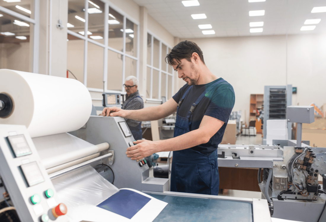 A printing press operator at work using environmentally friendly equipment.
